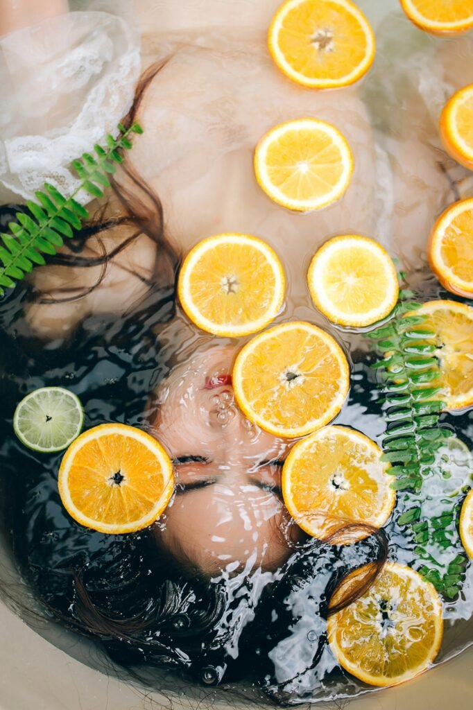 Fresh citrus slices floating on water, creating a refreshing and vibrant image for wellness and beauty themes.