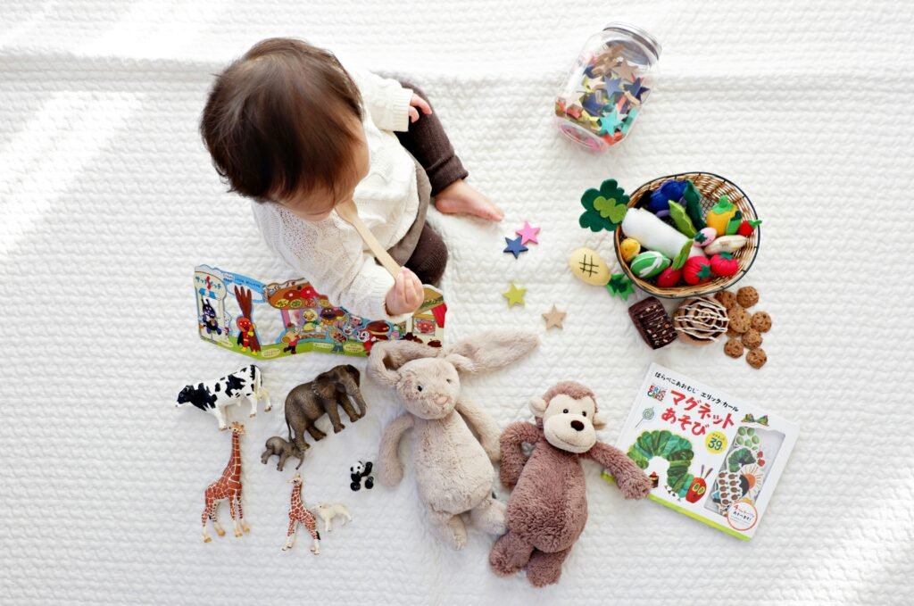 toddler playing with colorful toys on the floor surrounded by stuffed animals and playful decorations, creating a joyful and cozy atmosphere.